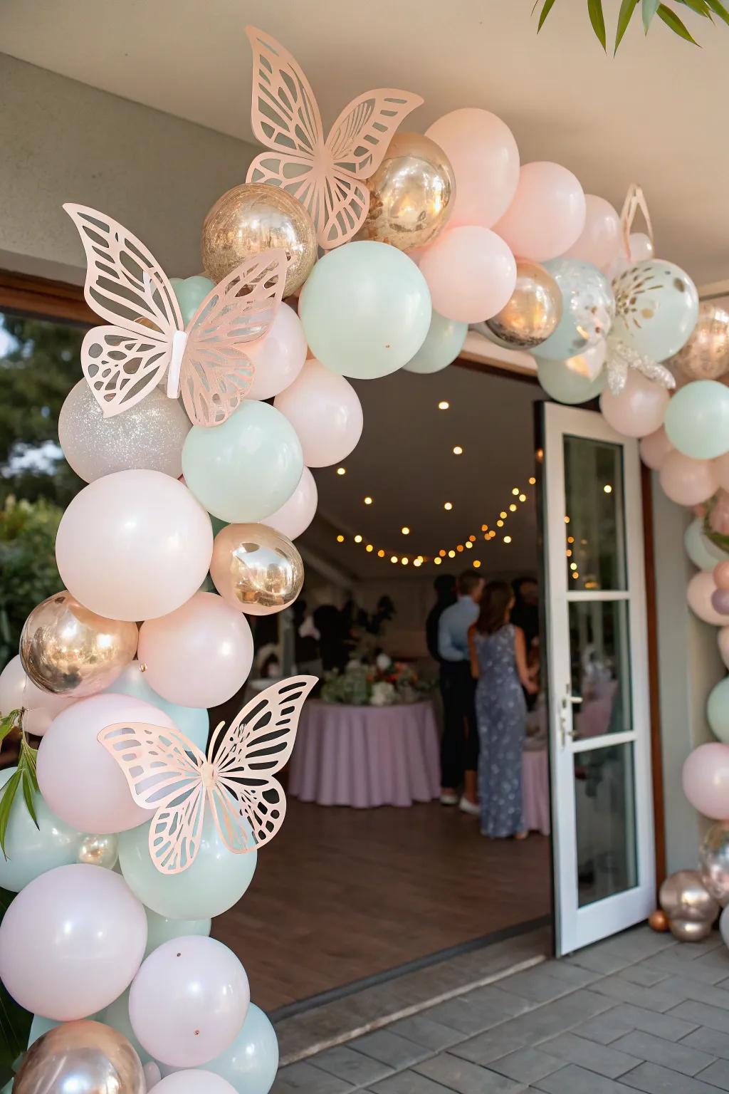 A dreamy balloon garland adorned with butterflies, warmly greeting guests at the celebration.