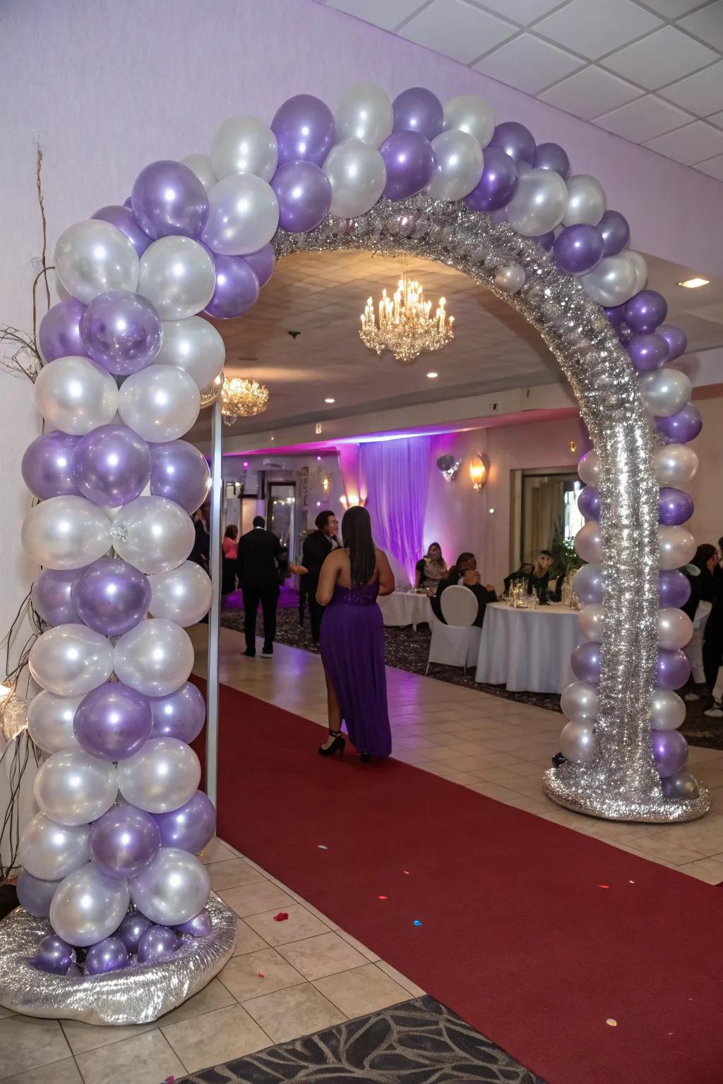 A breathtaking entryway featuring a lavender and silver balloon arch that welcomes guests with open arms.