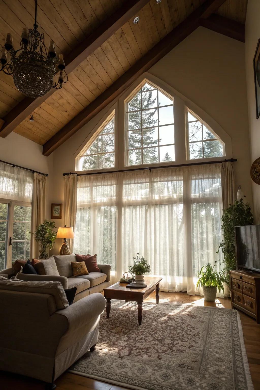 Sheer curtains beautifully filter natural light in this high-ceilinged living room.