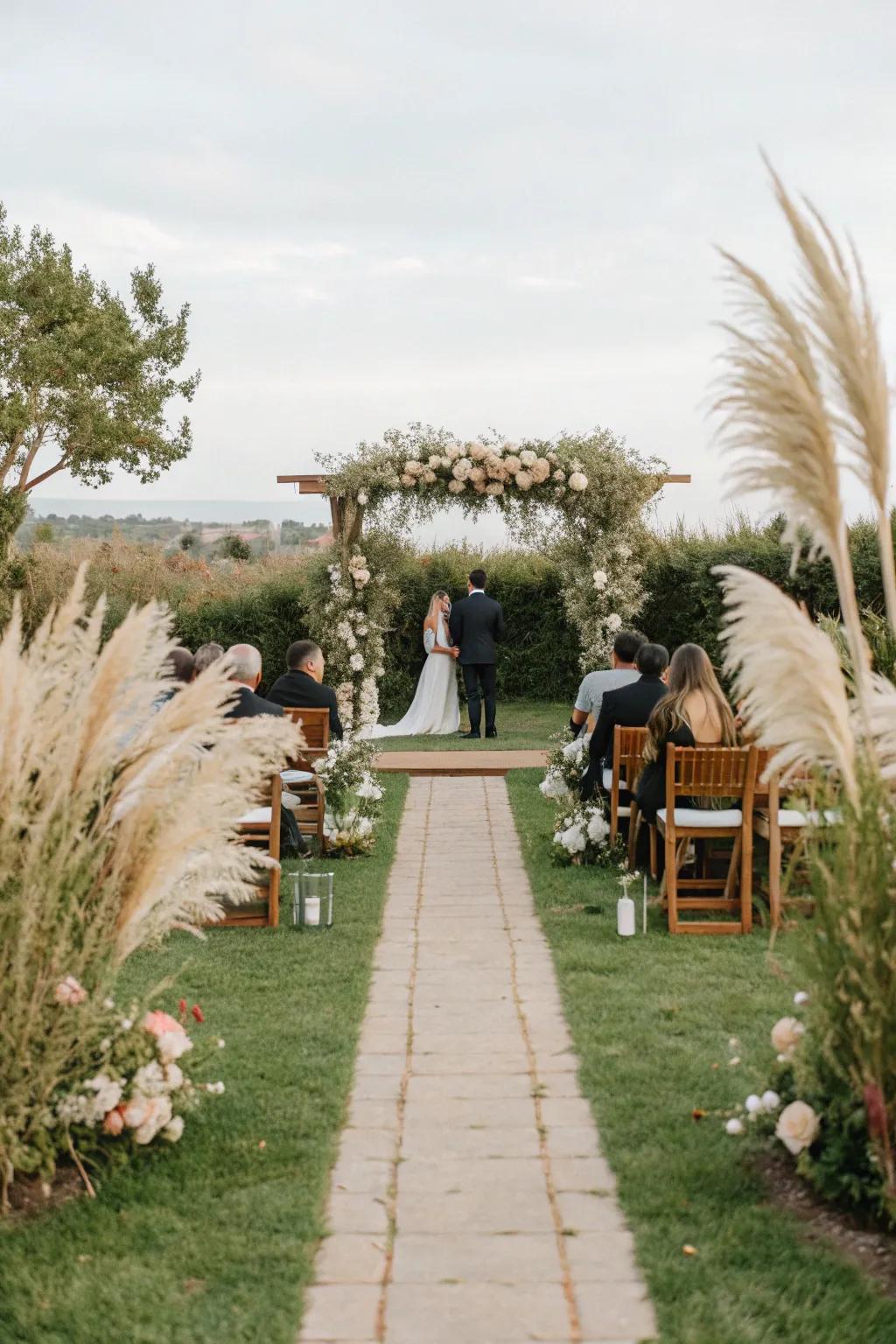 Graceful feathery reed compositions encircle a stunning marital platform.