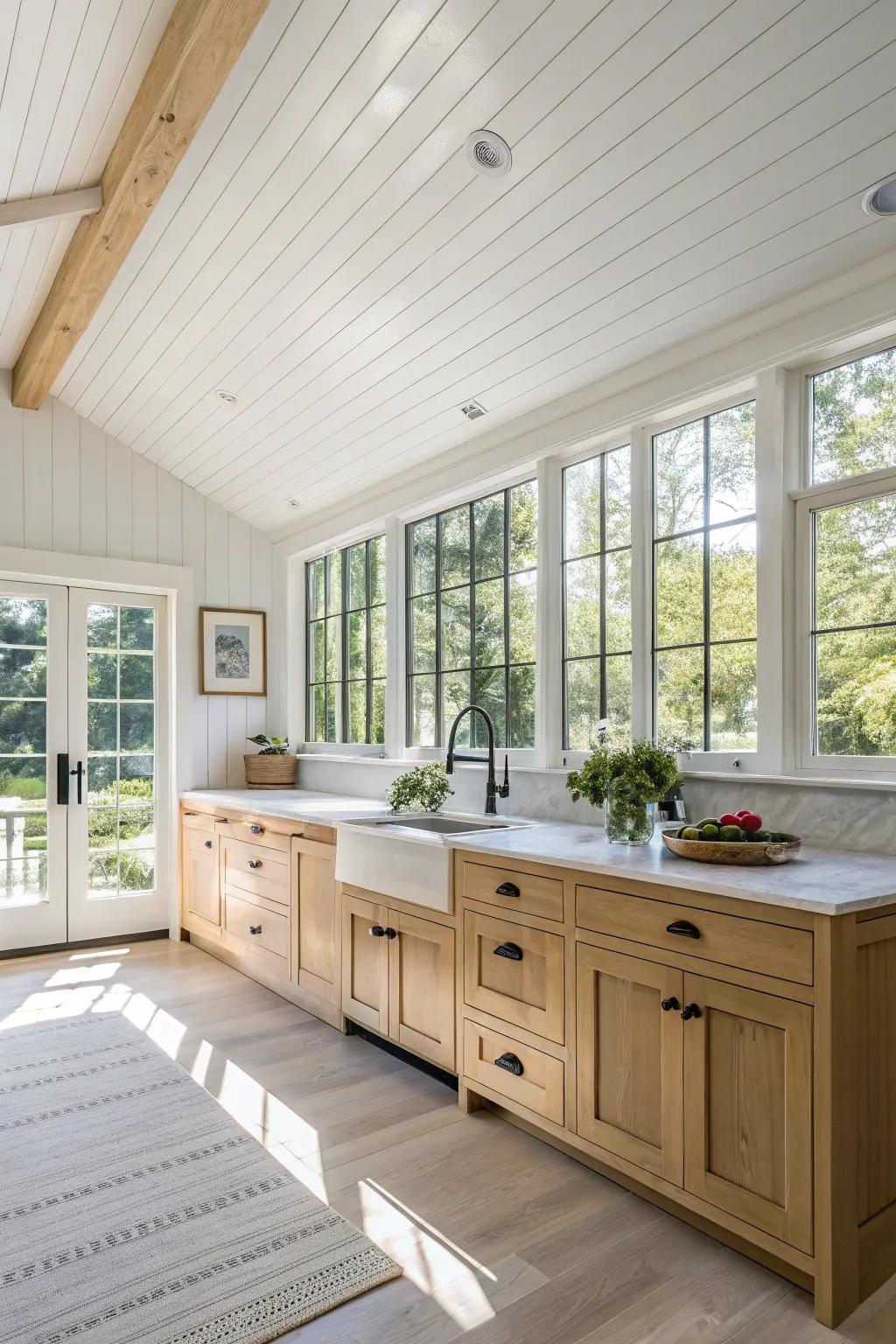 A timeless white shiplap ceiling graces a luminous kitchen environment.