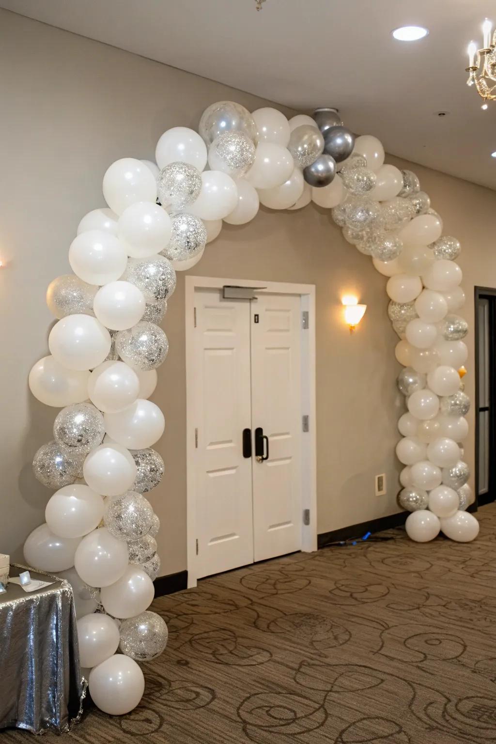 Celebrate life’s moments in style with a gorgeous white and silver balloon arch.