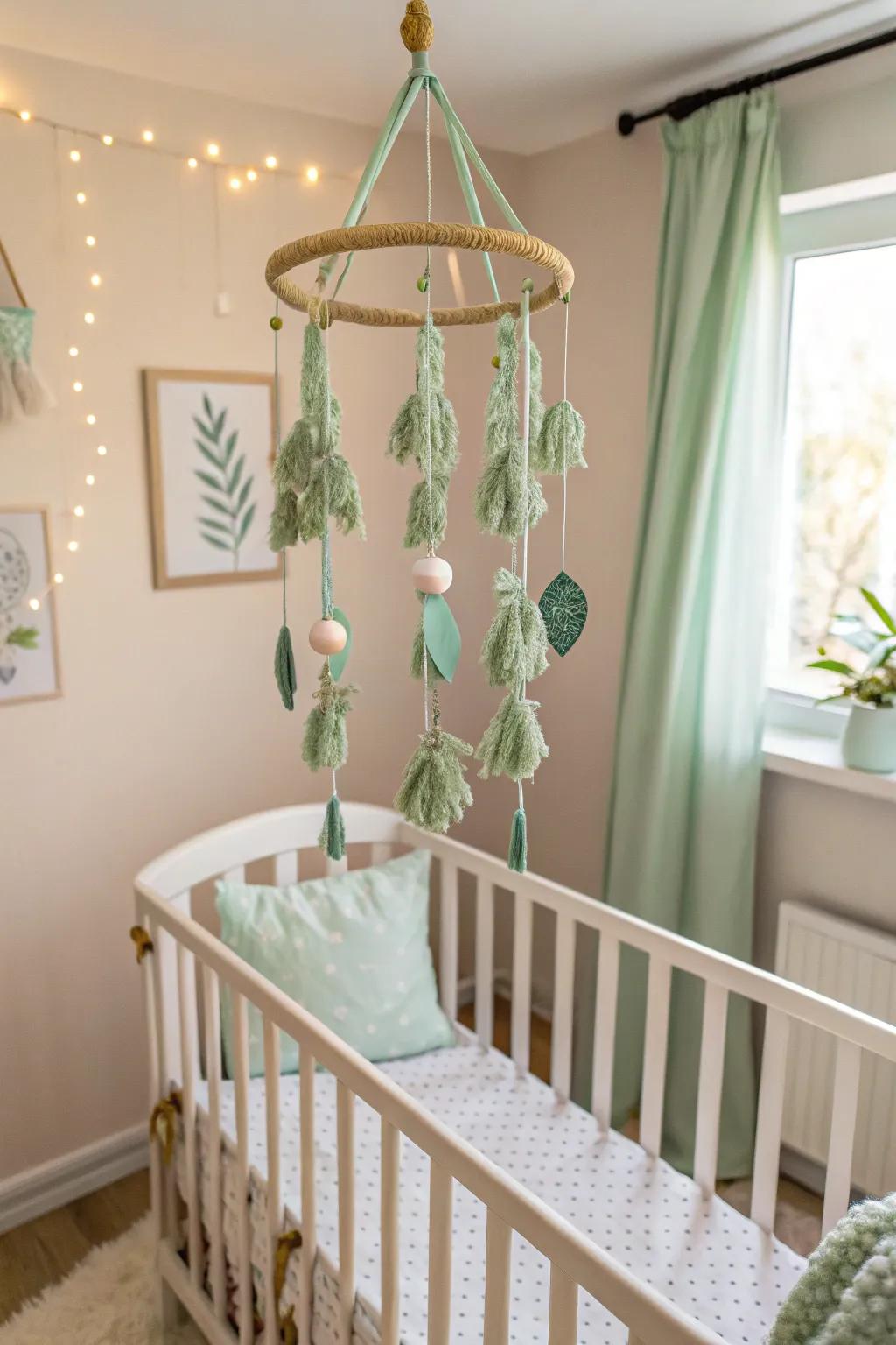 A DIY mobile adds dynamic visual interest to a soft leaf green nursery.