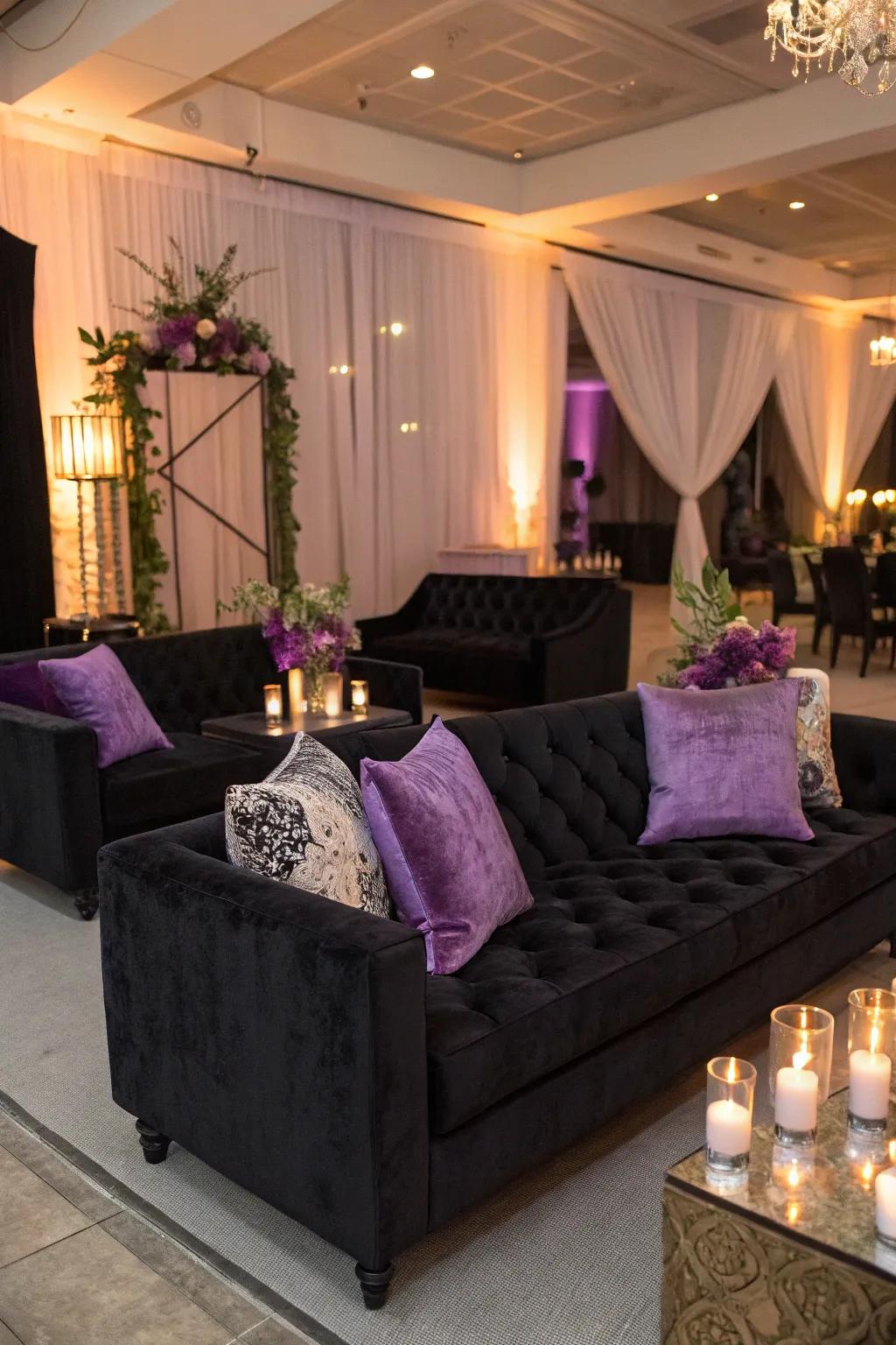 Luxurious lounge area with black velvet sofas and purple cushions.
