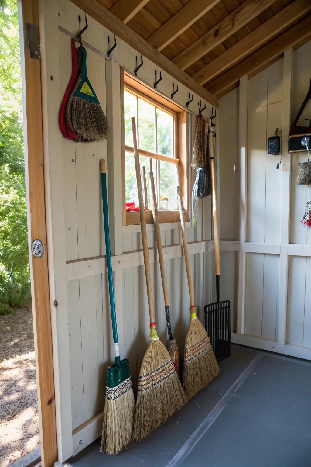 Preserve floor space through overhead broom storage.