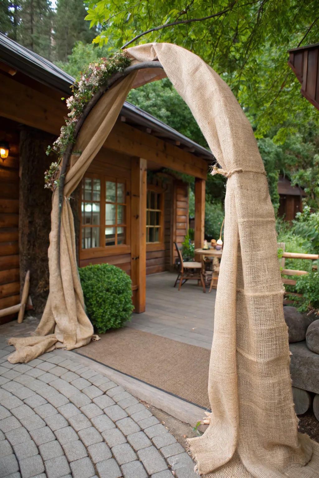 A rustic arch wrapped in burlap for a farmhouse-inspired look.