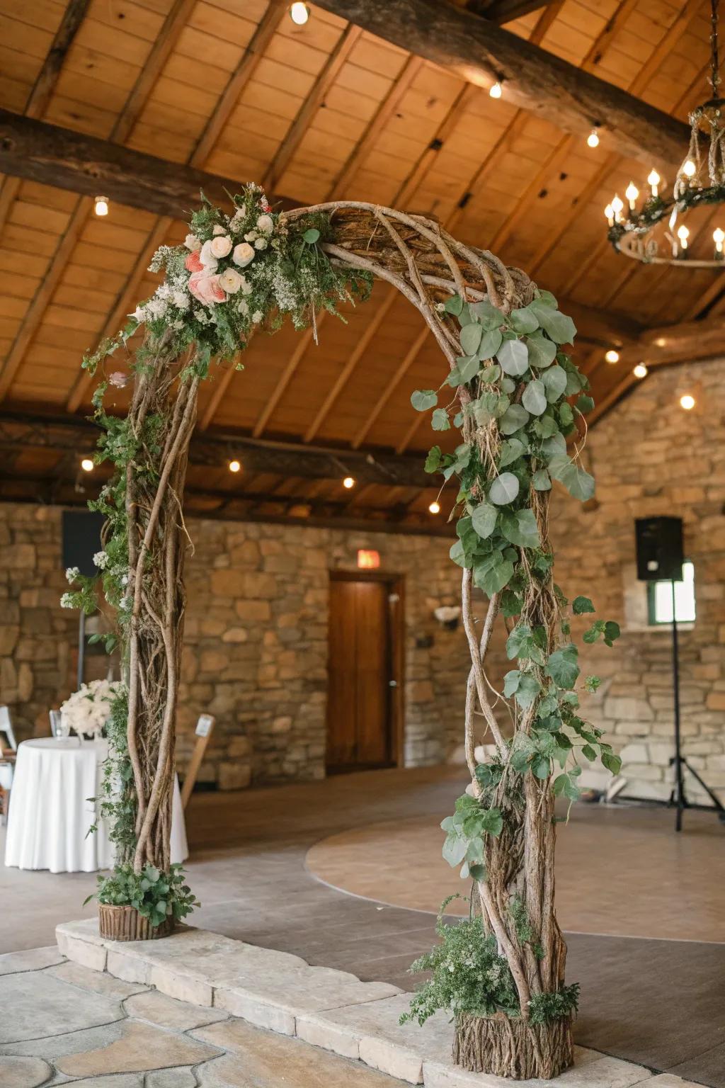 Unaltered limbs compose a country and organic wedding arch.