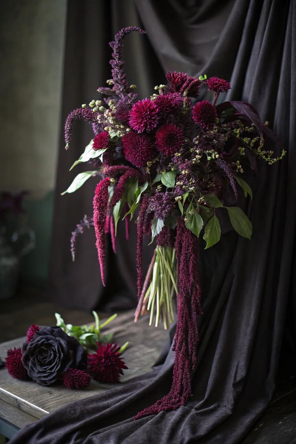 Hanging amaranth furnishes a descent of color and mystery to this alluring Halloween bouquet.