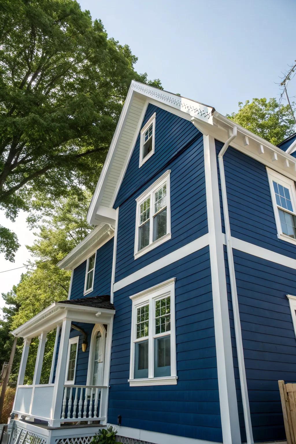 A house featuring a striking deep sea blue cladding and contrasting white accents.