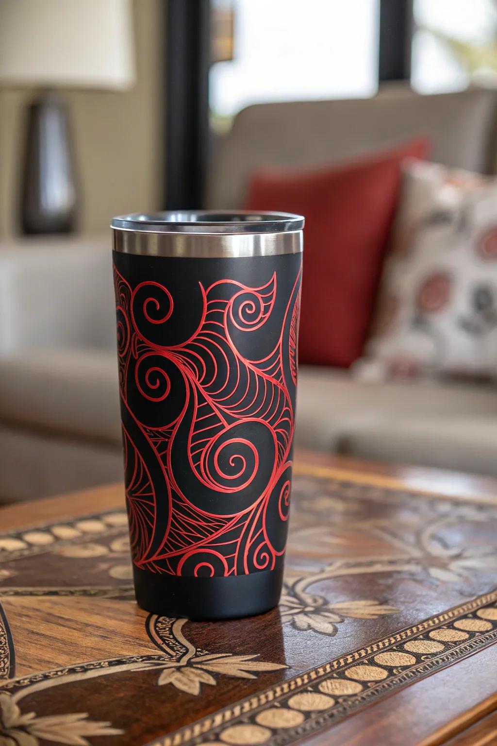 Conceptual crimson spirals on a dark tumbler evoke a spirited appearance.