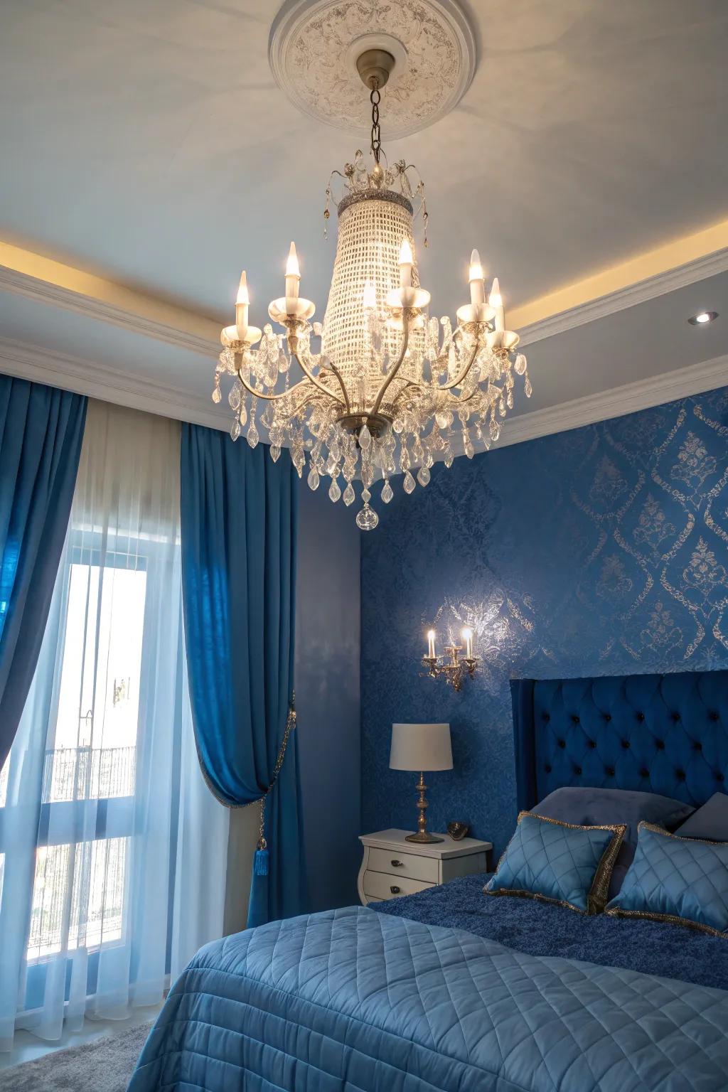 A crystal chandelier enhances sophistication to a sapphire-themed bedroom.