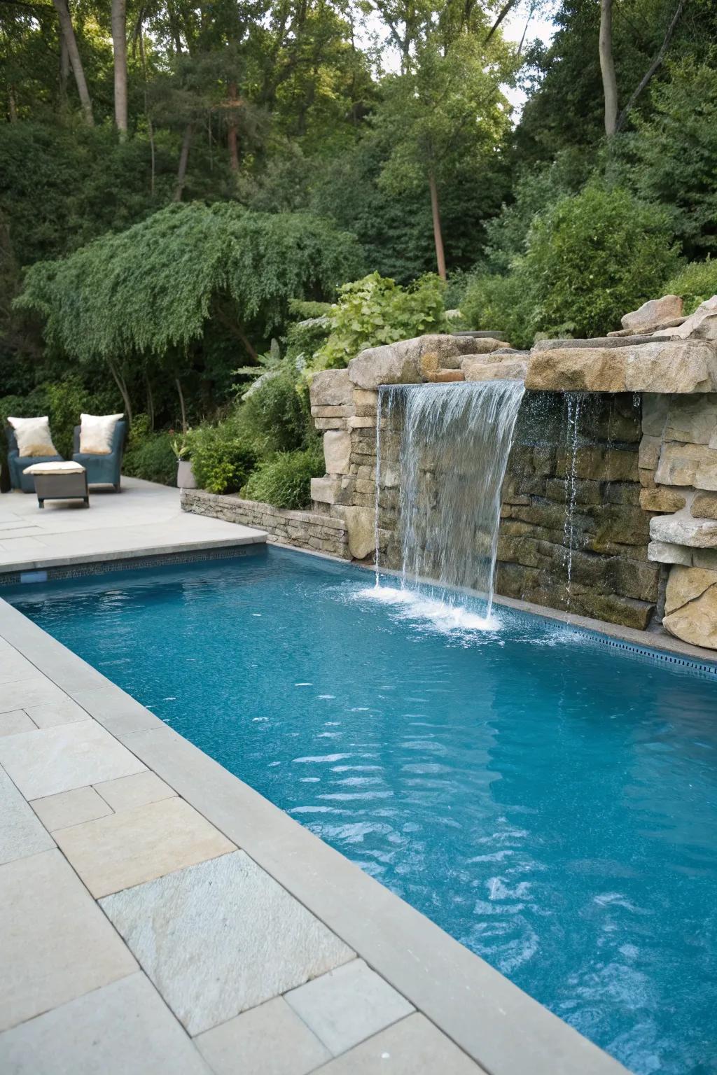 A waterfall element appends sophistication and tranquility to the pool.