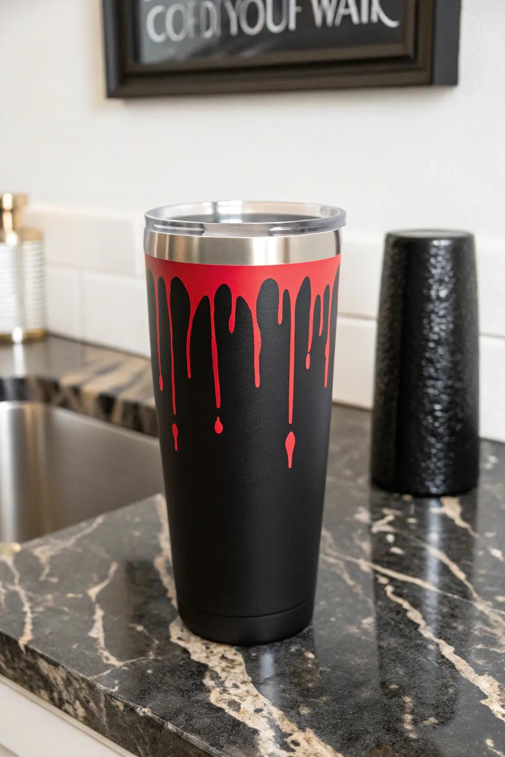 A daring crimson droplet pattern that introduces drama to a dark tumbler.