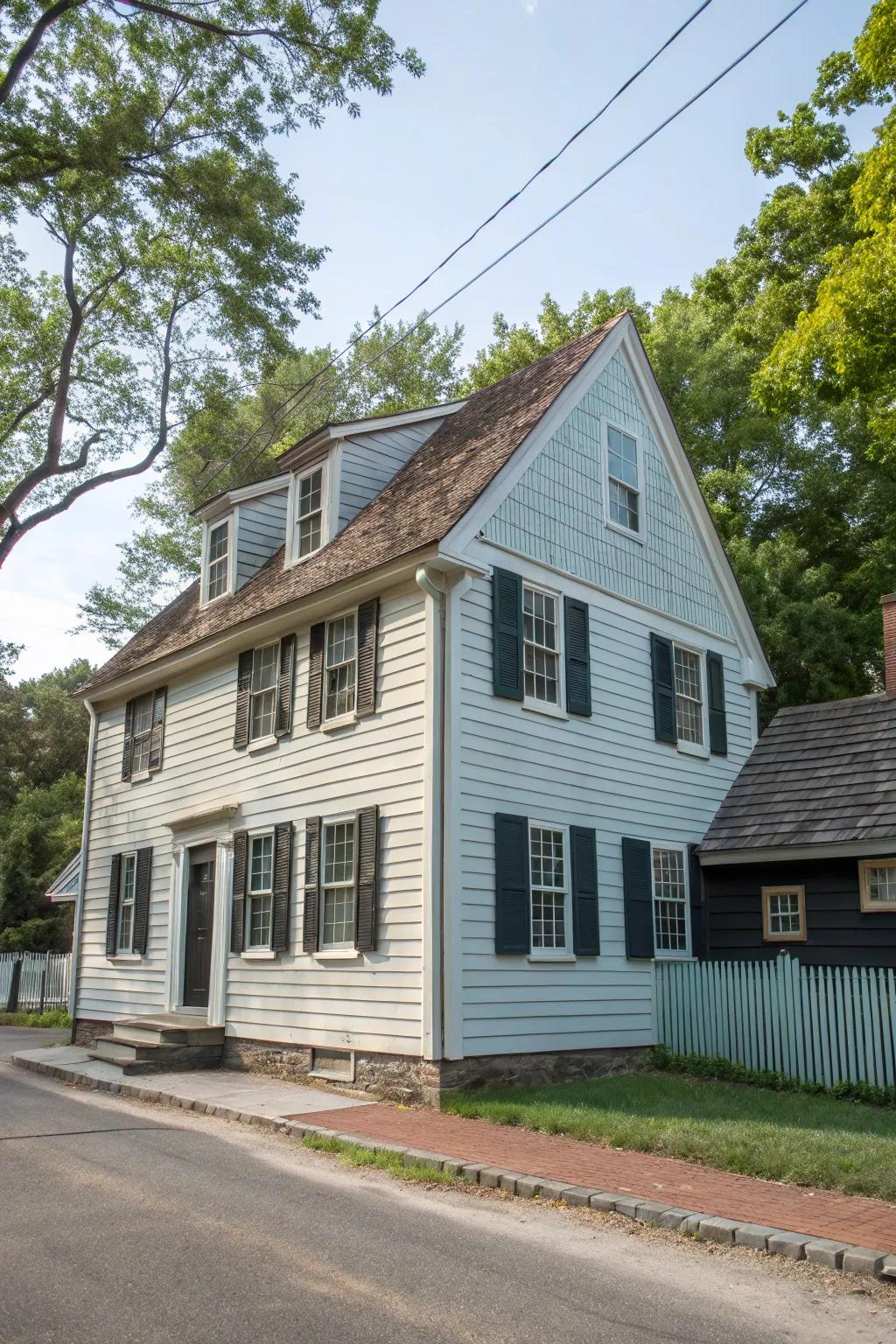 A colonial house showcasing a stylish dual-tone facade with siding and roofing.