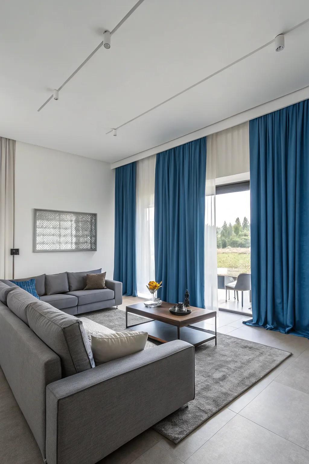 Sky-hue drapes and ash furniture create a contemporary, harmonious living space with a balanced color scheme.