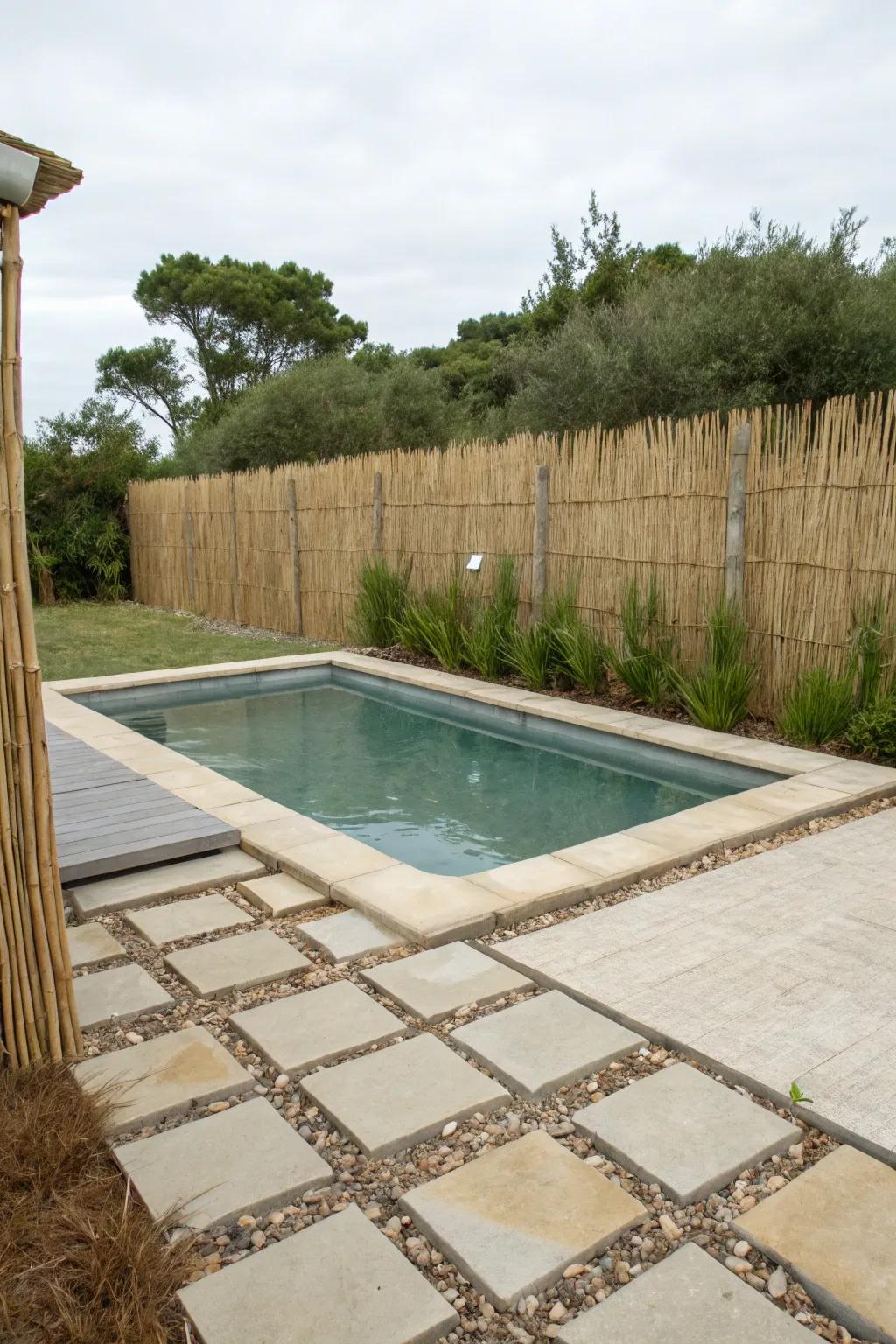 A thatch barrier creating a peaceful, beachy atmosphere by the pool.