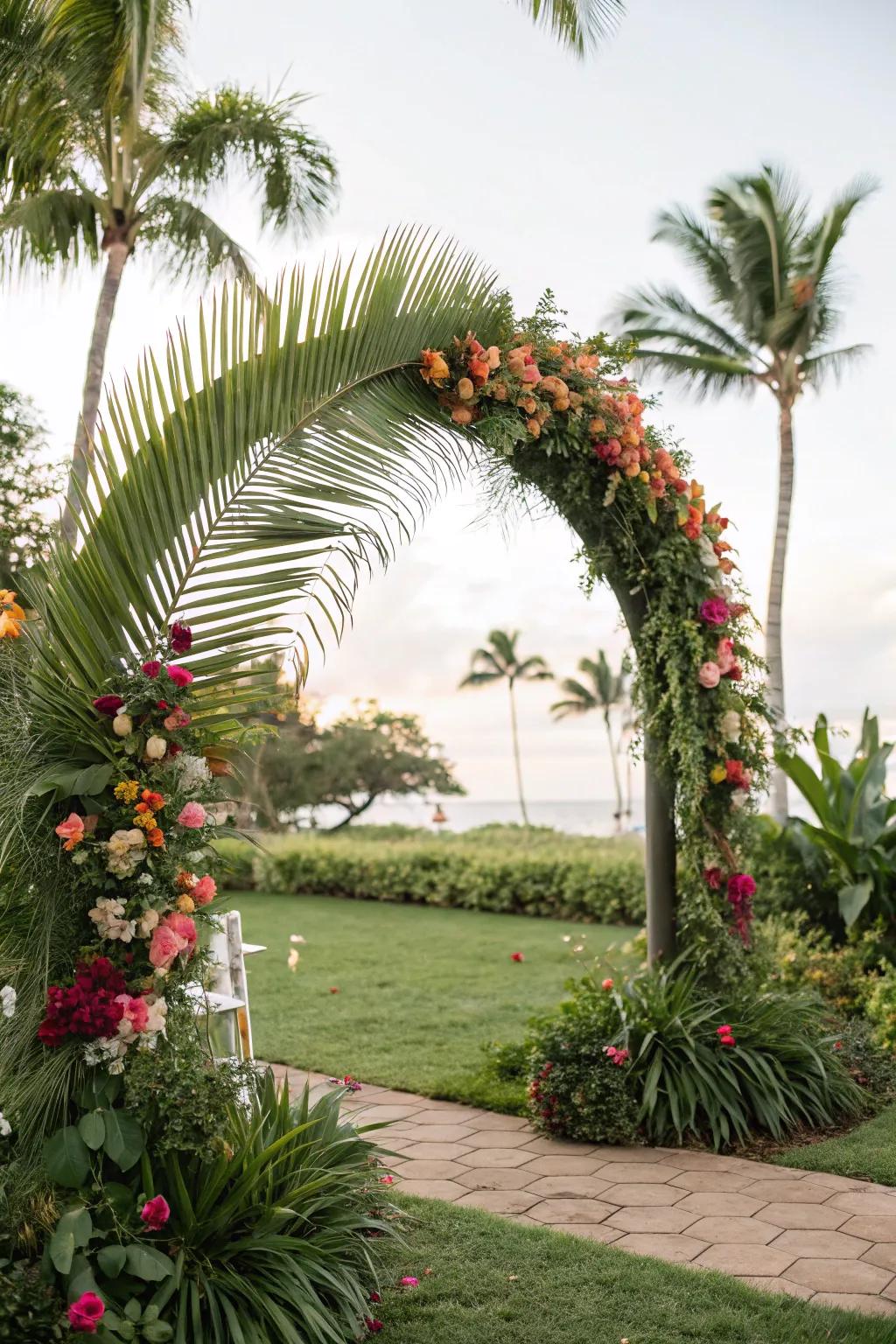 A tropical arch embellished with palm fronds and vibrant blossoms.
