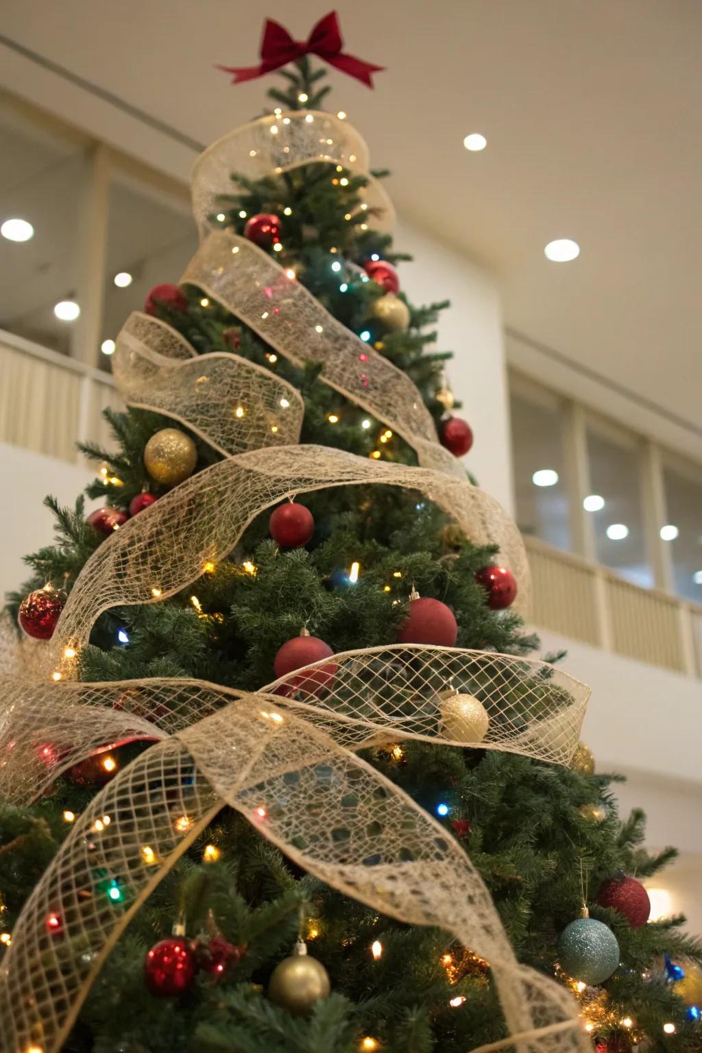A Christmas tree with mesh ribbons woven through the branches, adding texture and dimension.