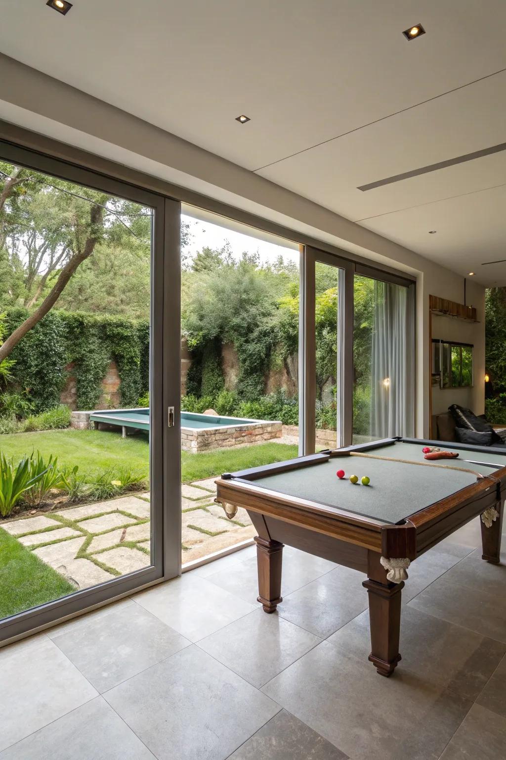 An indoor-outdoor living space complete with a pool table and garden access.