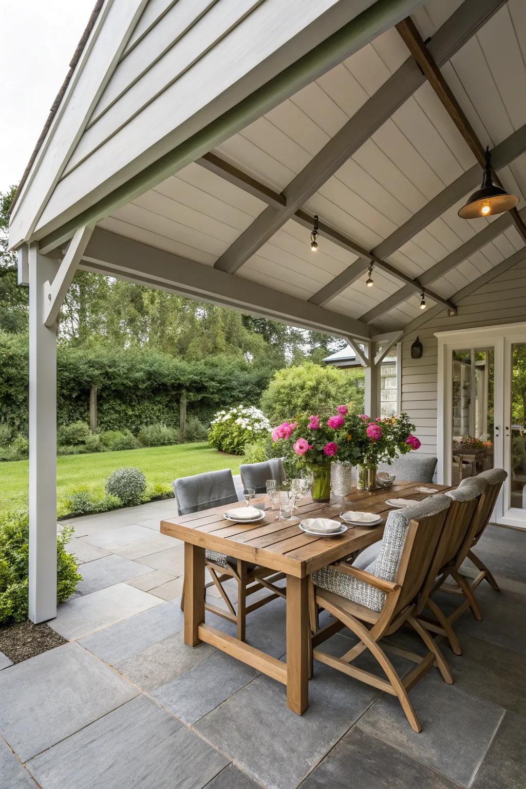 A porch extension with a dining area under a roof extension.