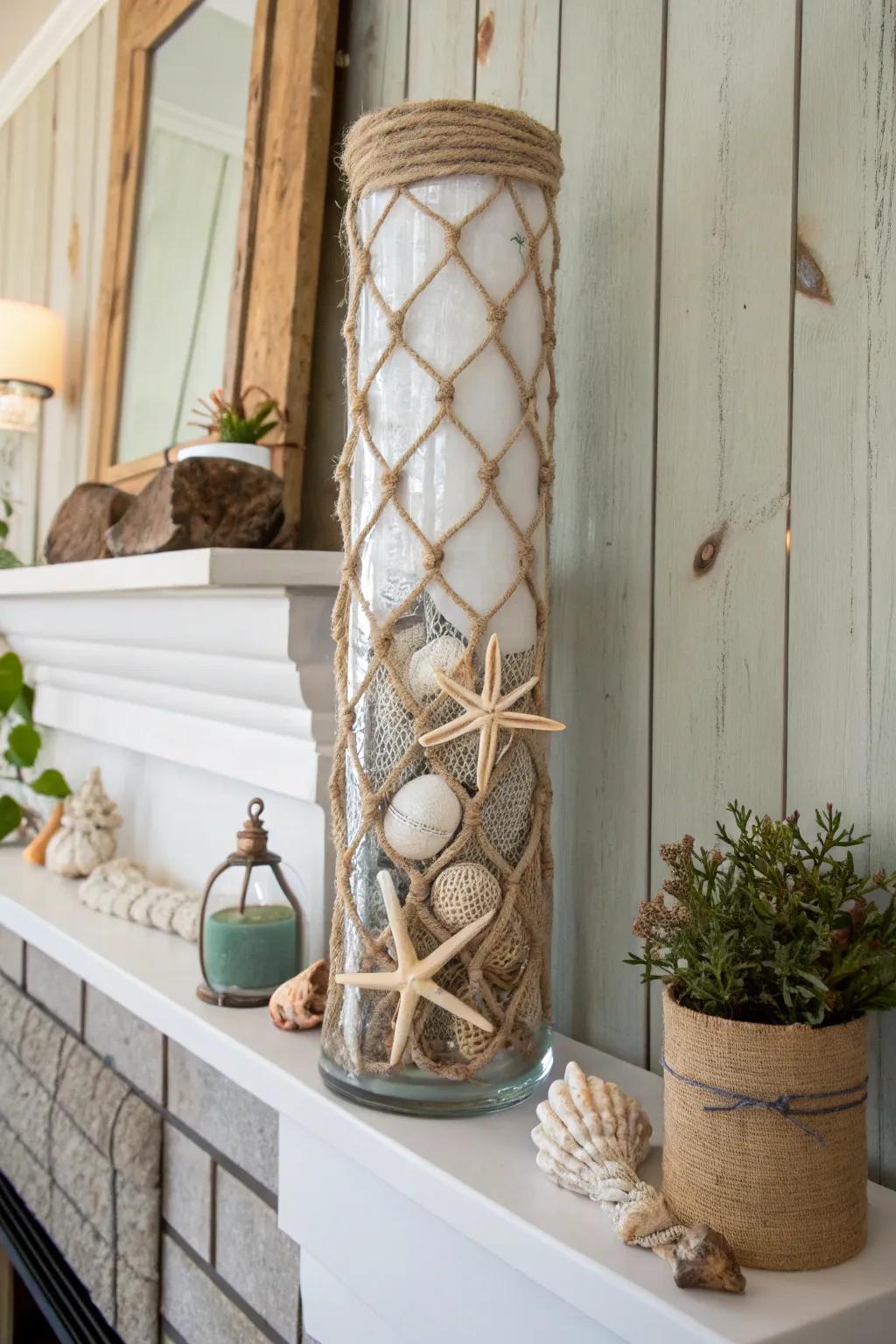 A nautical-themed tall glass vase encased in rope, adorned with seashells upon a coastal ledge.