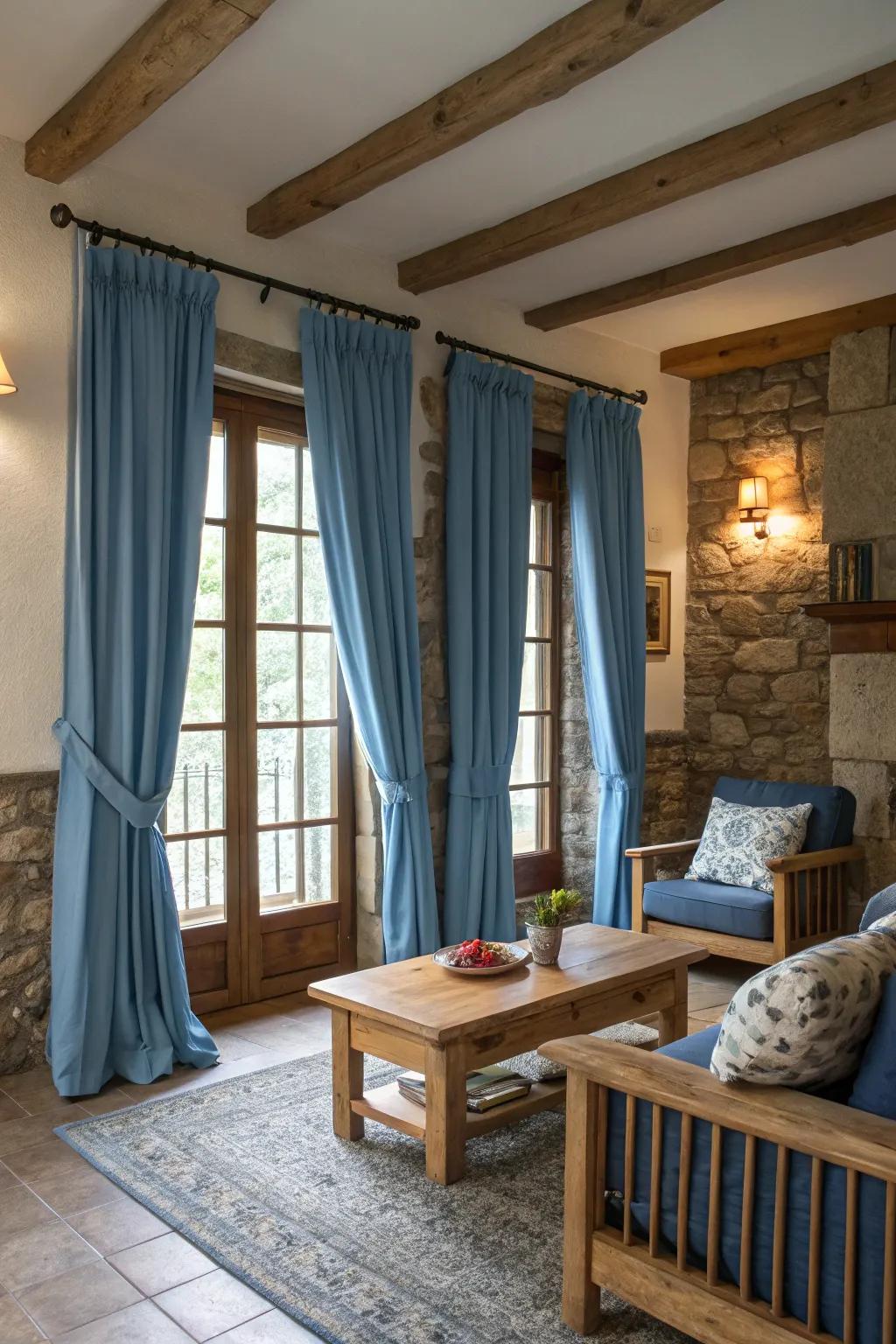 Earthy elements such as timber and stone complement sky-hue drapes, enriching the area with warmth and texture.