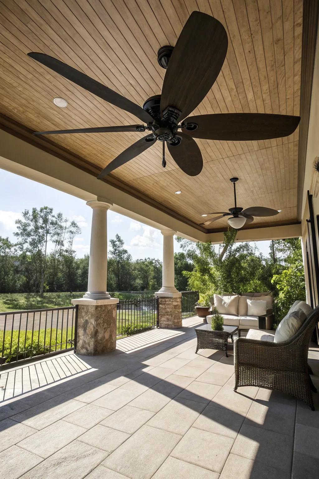 A spacious patio accentuated by a ceiling fan with oversized blades.