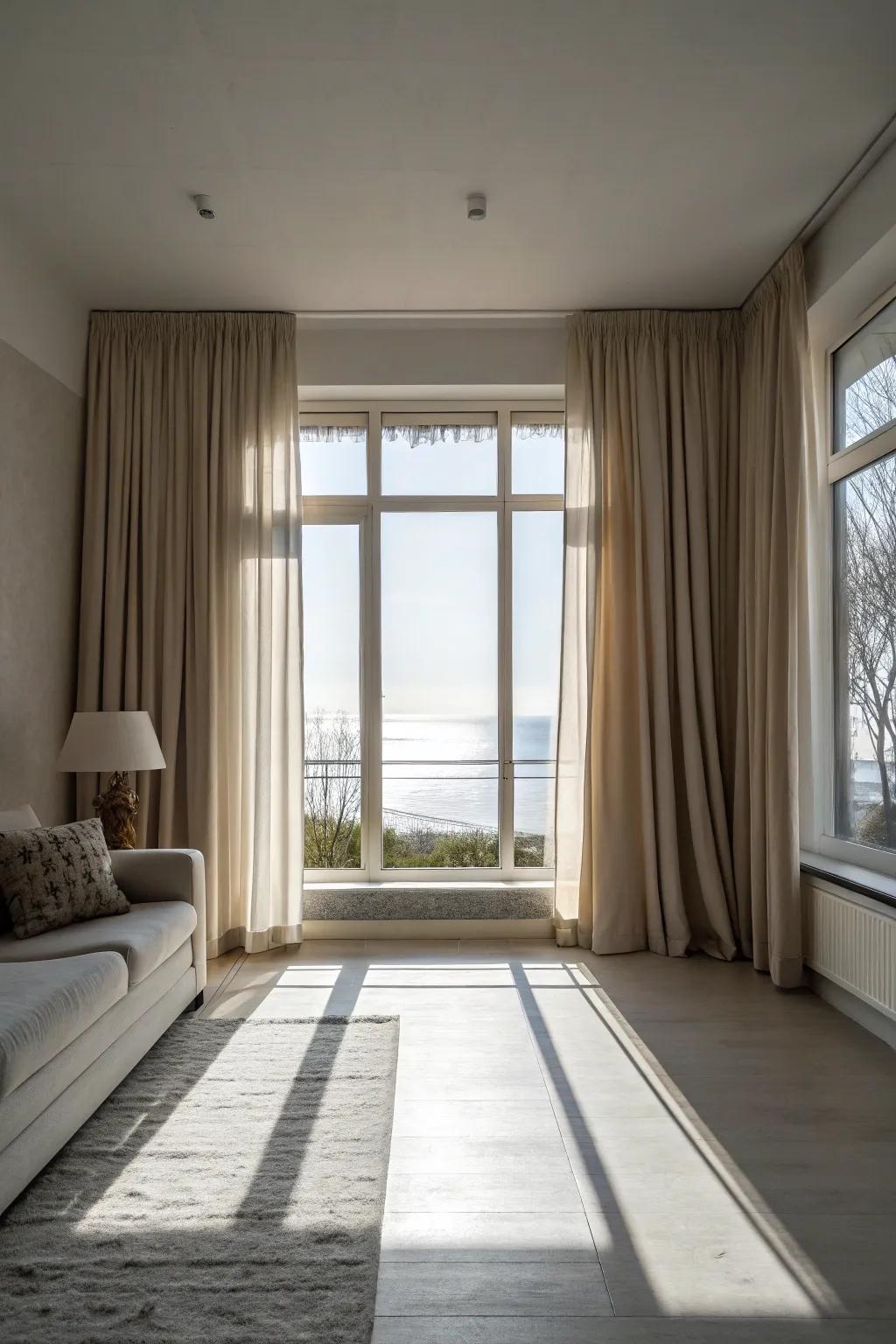 Minimalist living space with neutral tone curtains that frame a picture window.